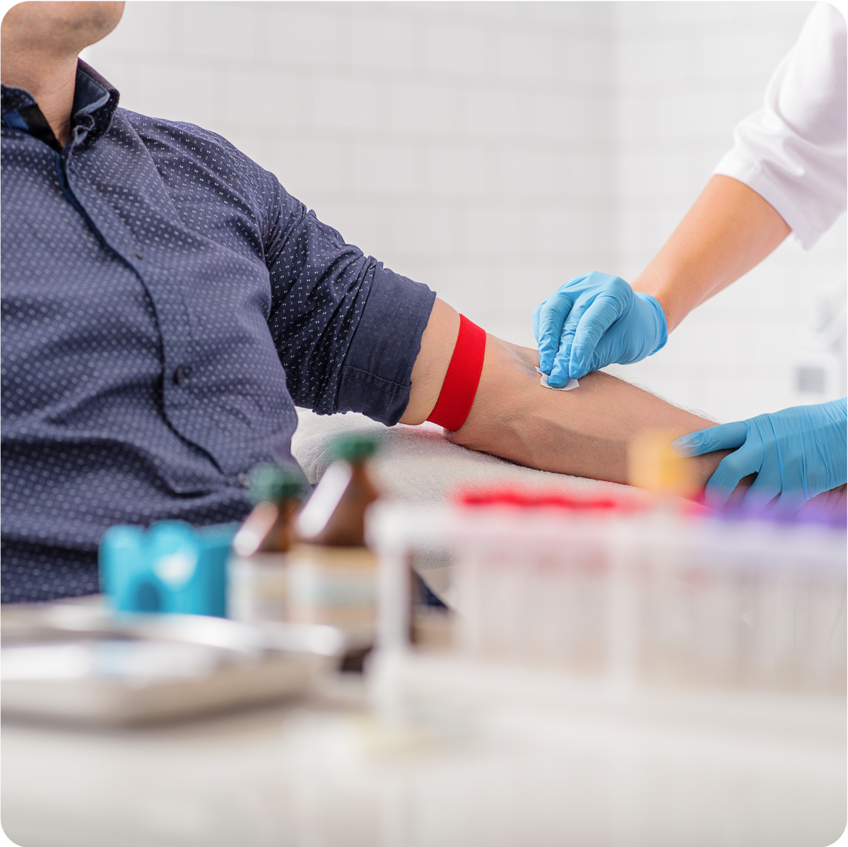 A man is getting a blood test in a lab.
